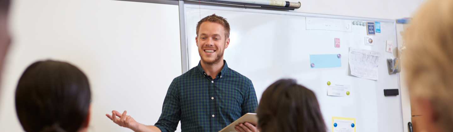 Image of a teacher engaging with classroom of pupils in school