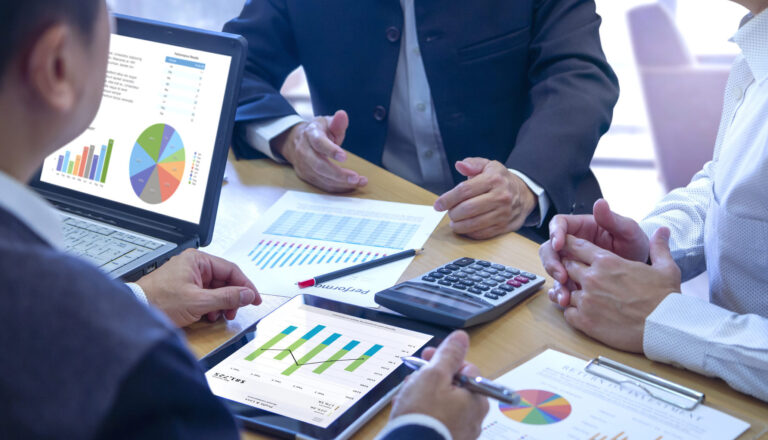 Business leaders reviewing reports in a meeting