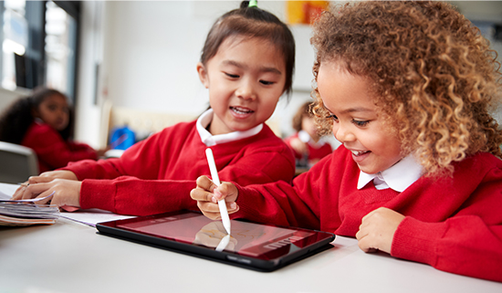 Image of two primary school aged children using a tablet
