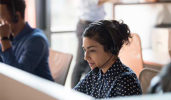 Image of a helpdesk operator working at a desk