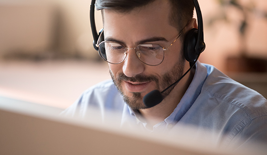 Image of a helpdesk operator taking a call on his headset