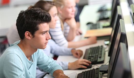 Image of students operating computers in school