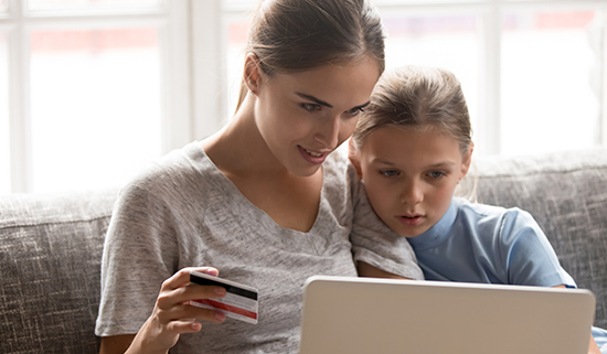 Image of parent and child viewing a laptop screen