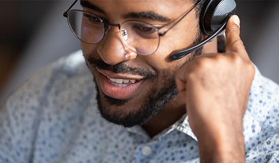 Close up of a male helpdesk operator talking on his headset