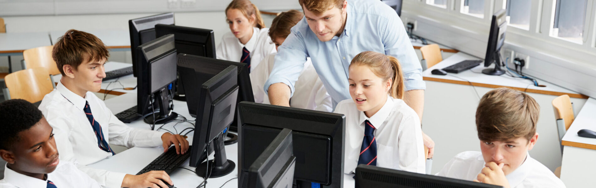 Teacher and secondary school pupils in a classroom