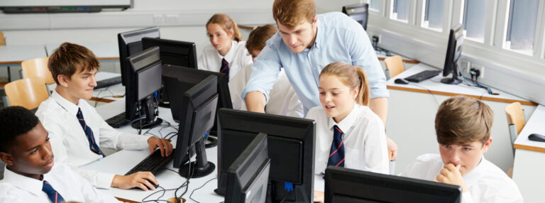 Teacher and secondary school pupils in a classroom