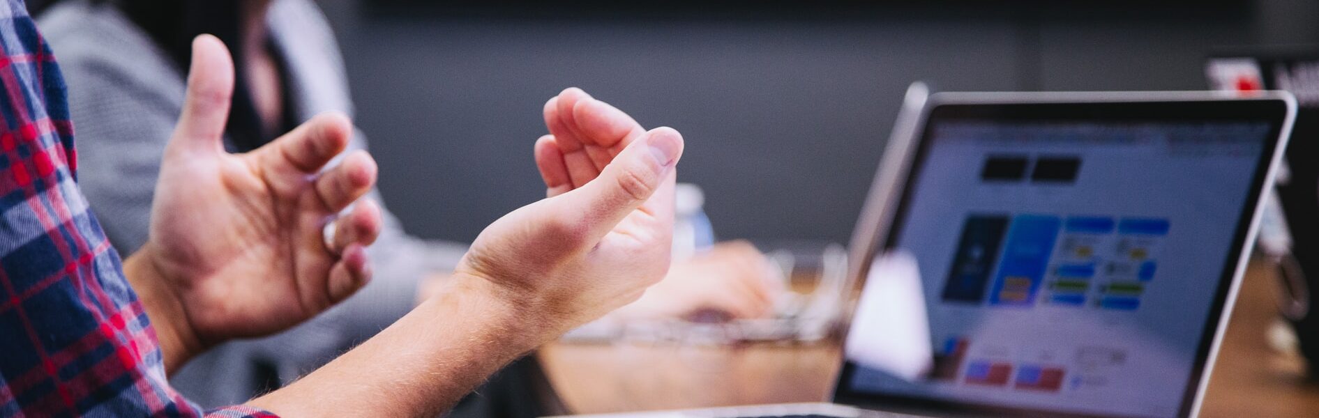 Image close up of hands animated with laptop screen in the background