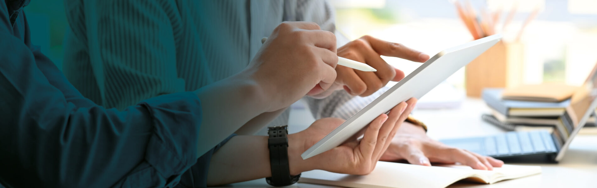 Two business people viewing a tablet device