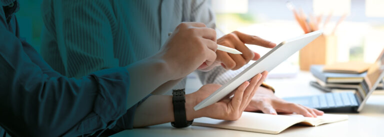 Two business people viewing a tablet device