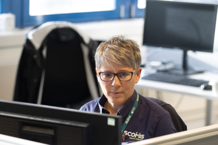 Head and shoulder shot of lady taking a service desk call