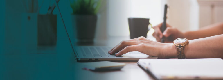 Close up of female hands typing on laptop keyboard